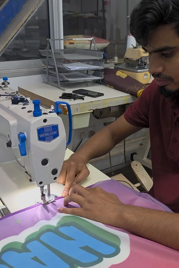 Scapemedia team member sewing printed fabric